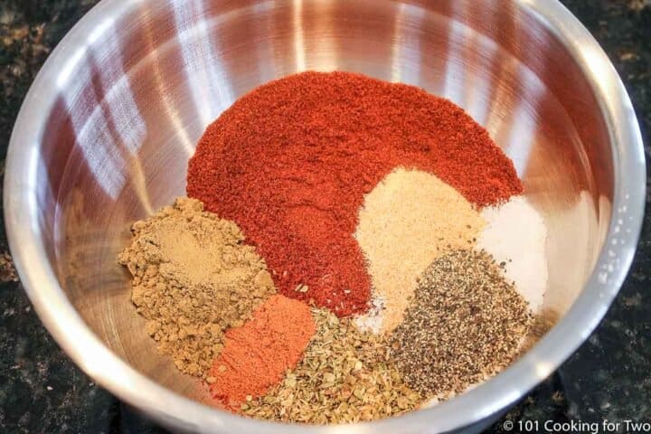 mixing spices in a metal bowl
