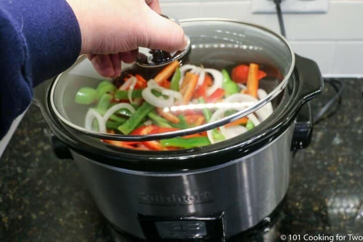 placing lid on the crock pot