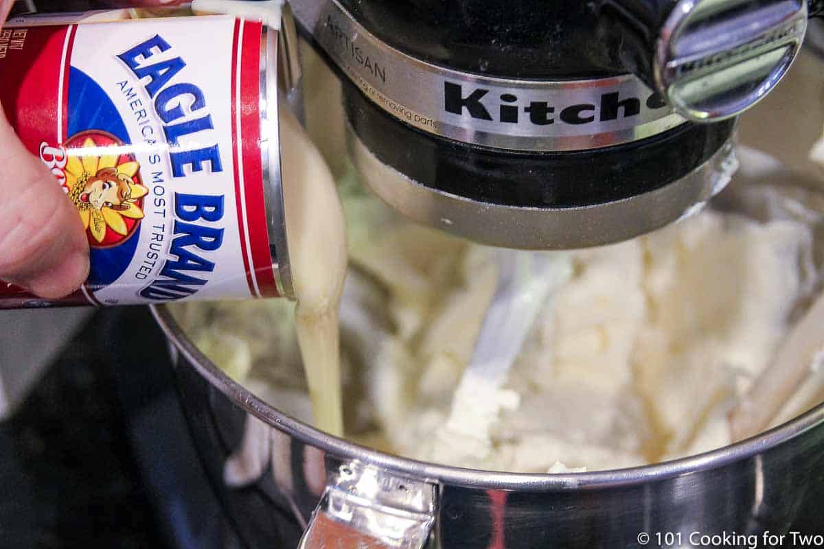 pouring sweetened condensed milk into stand mixer