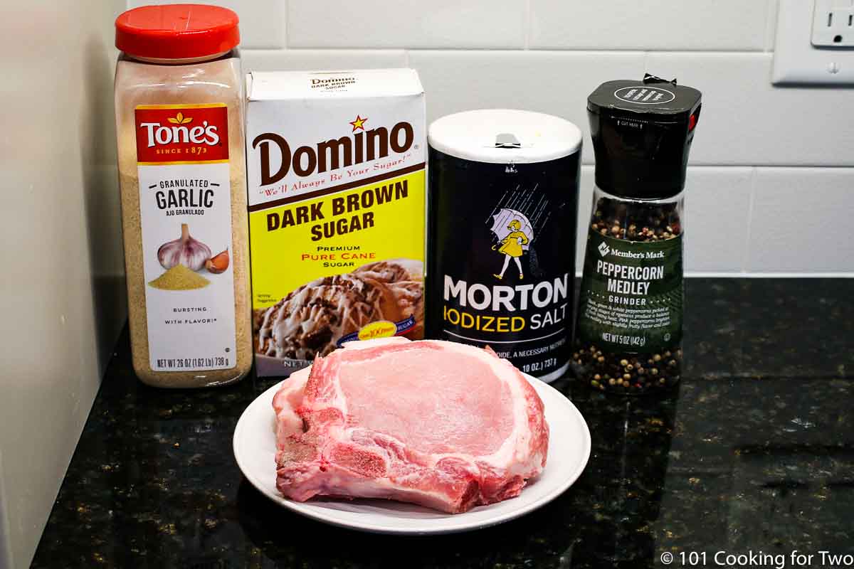 raw pork chops with seasonings.