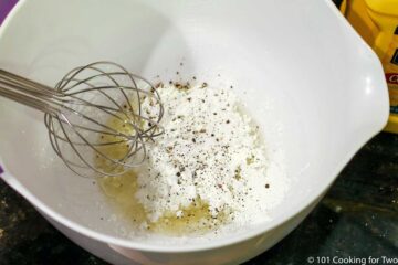 whisking coating ingredients in a white bowl
