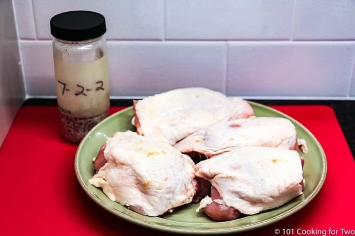 chicken thighs on a green plate