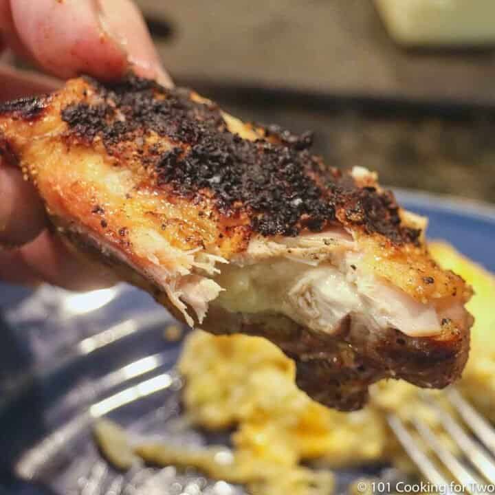grlled chicken thigh with bite out of it