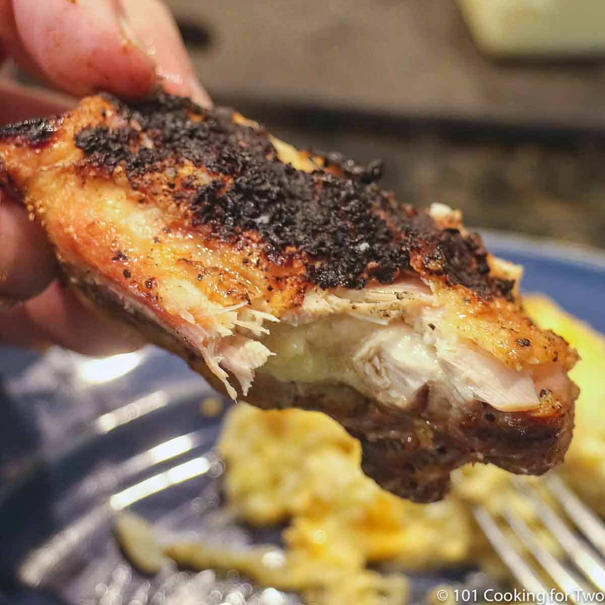 grlled chicken thigh with bite out of it.