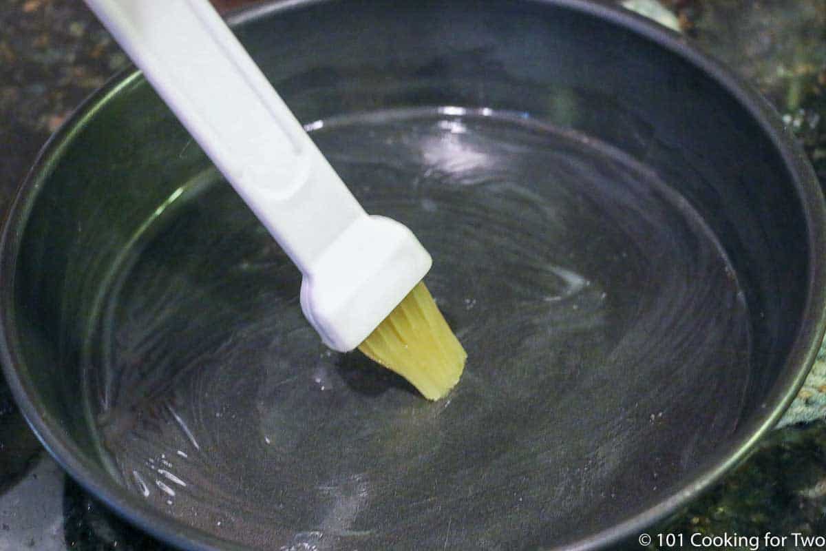 brushing pan with butter