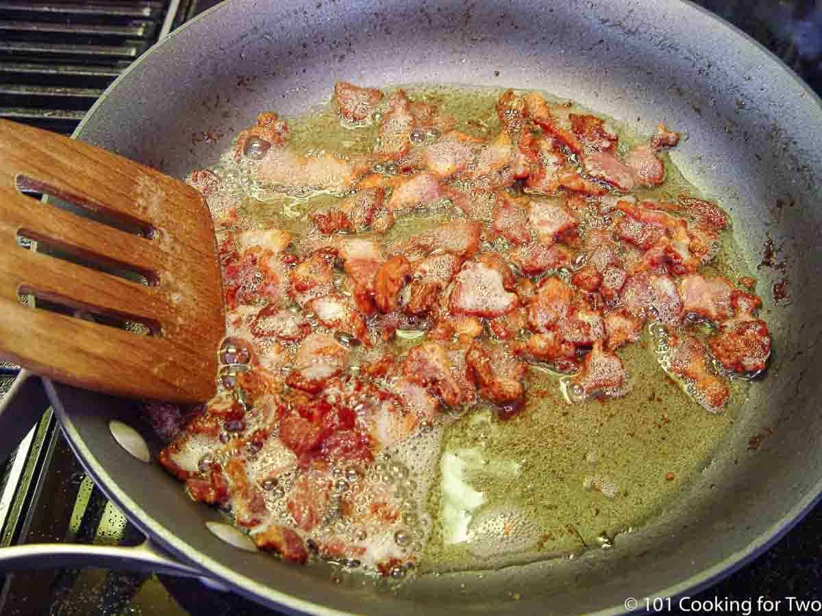 cooking cut bacon in skillet.