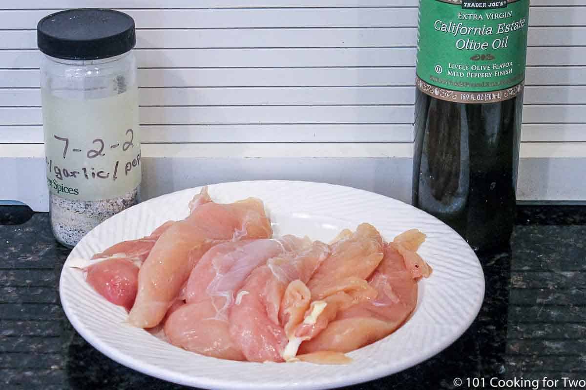 raw chicken tenders with oil and seasoning