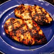 cooked chicken breasts on a blue plate