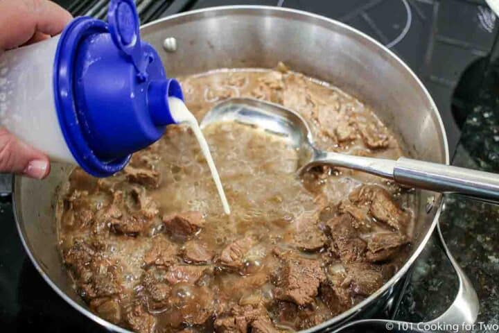 pouring flour mixture into beef mixture
