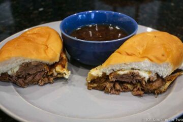 French dip sandwich with au sauce on gray plate