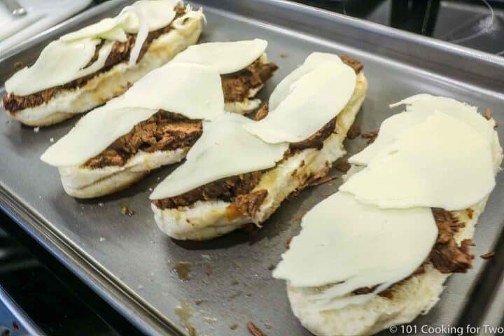 French dip sub with cheese on tray