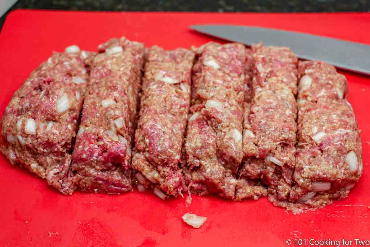 meat formed into loaf cut into equal pieces.