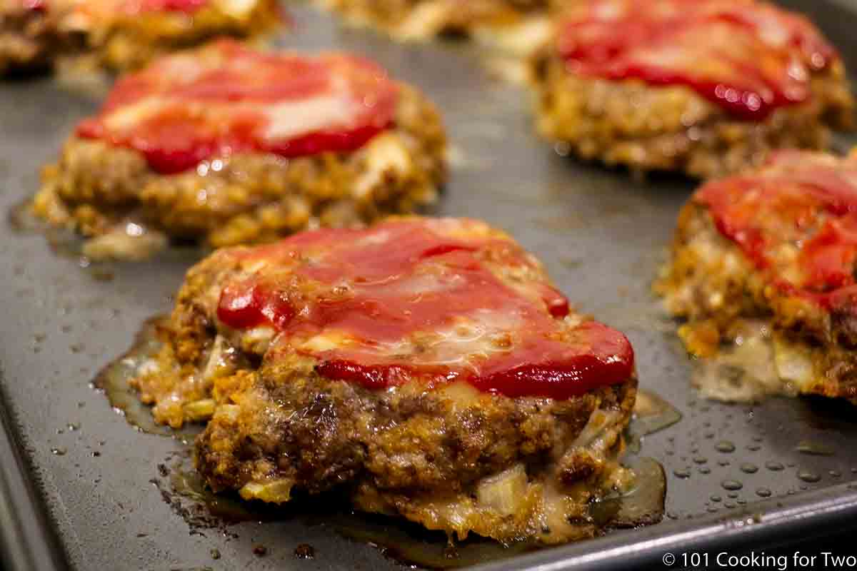 wide view of meatloaf burger on baking tray.