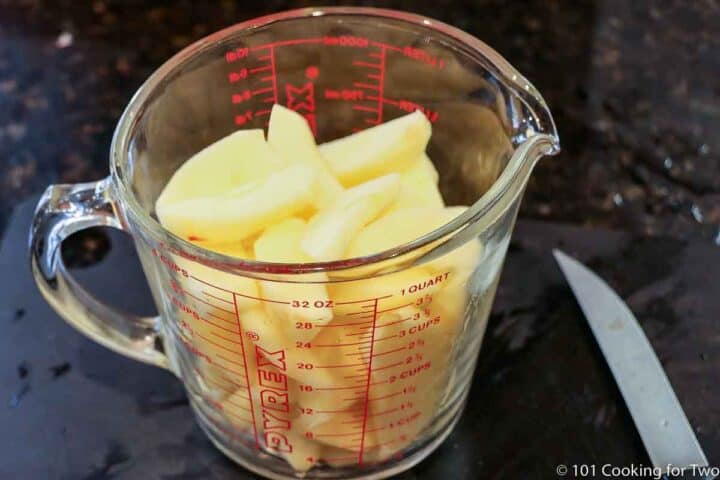 prepared apples in a measuring cup
