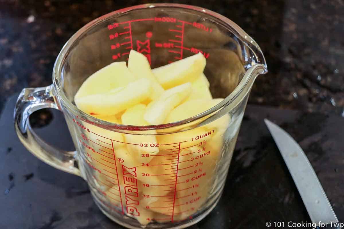 prepared apples in a measuring cup.
