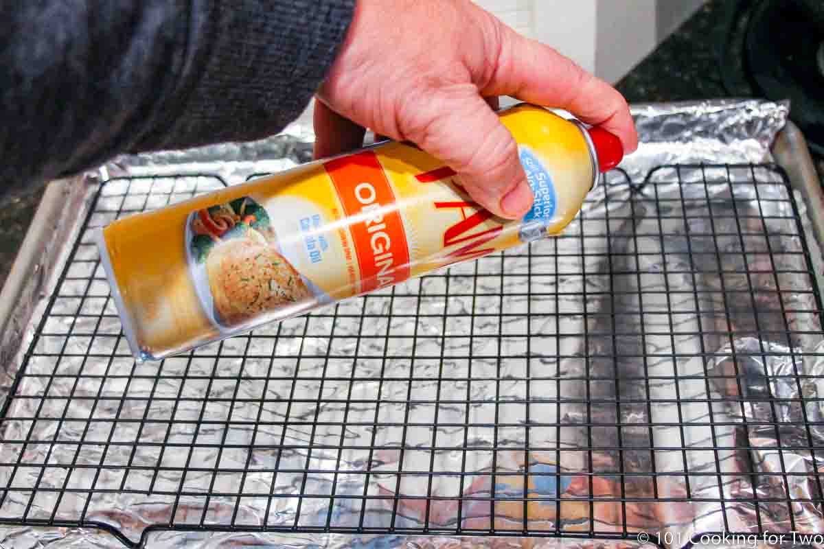Spraying PAM on a tray with a rack