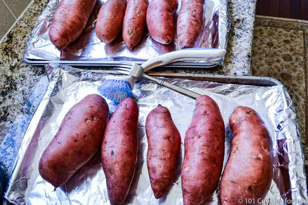 Uncooked sweet potatoes on baking tray.
