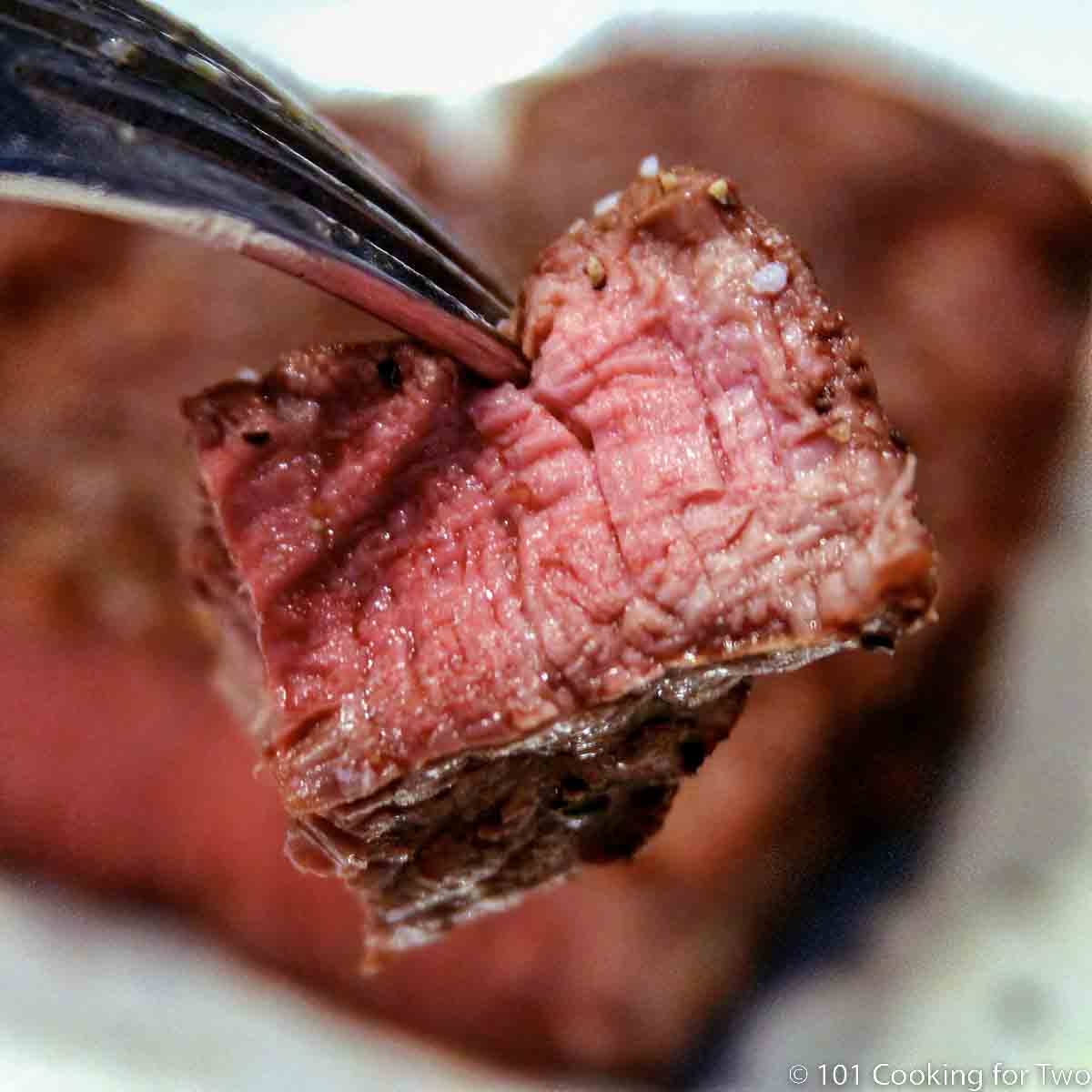 bite of filet on a fork.