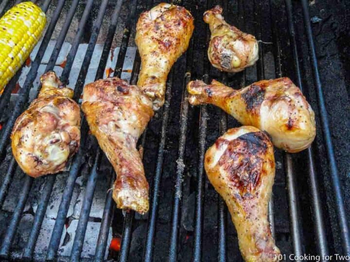 chicken drumsticks cooked on the grill with corn