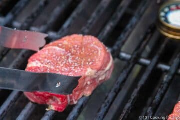 placing filet on a grill grate