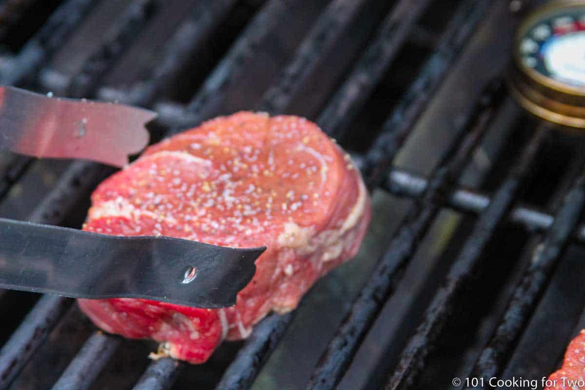 placing filet on a grill grate.
