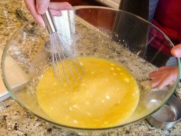 whisking wet ingredients together in glass bowl