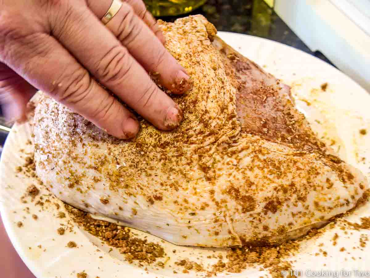 Rubbing tthe brown sugar rub on the turkey