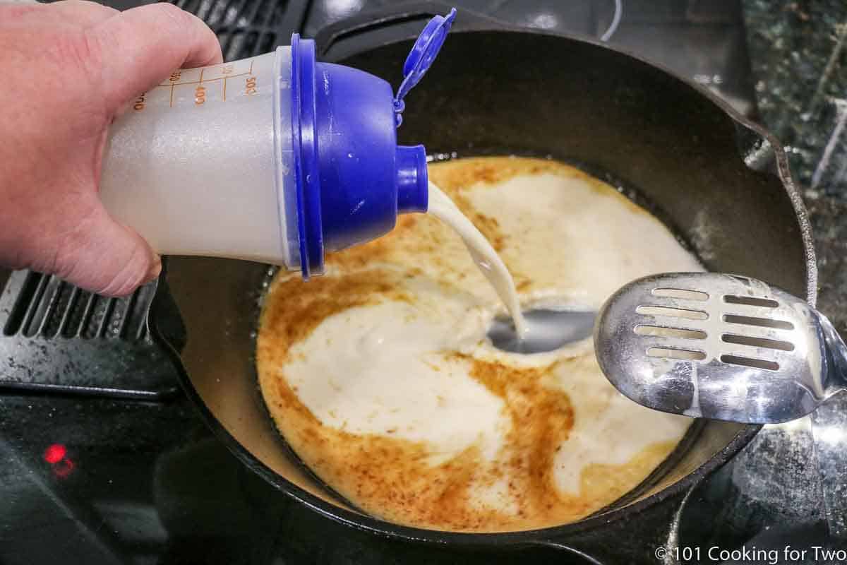 adding flour slurry to pan to make gravy.
