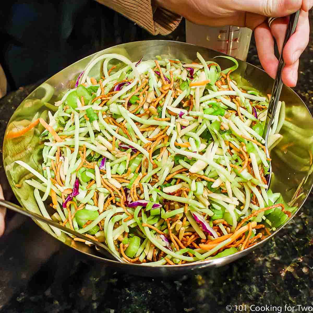 broccoli slaw salad in a metal bowl.