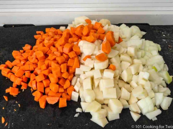 chopped potatoes and carrots on black board