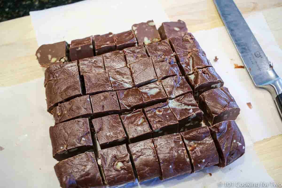 fudge cut into pieces on parchment paper.