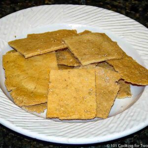 pile of sesame Parmesan crackers on white plate