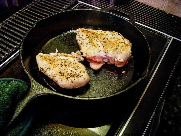 seared chicken breasts in black skillet