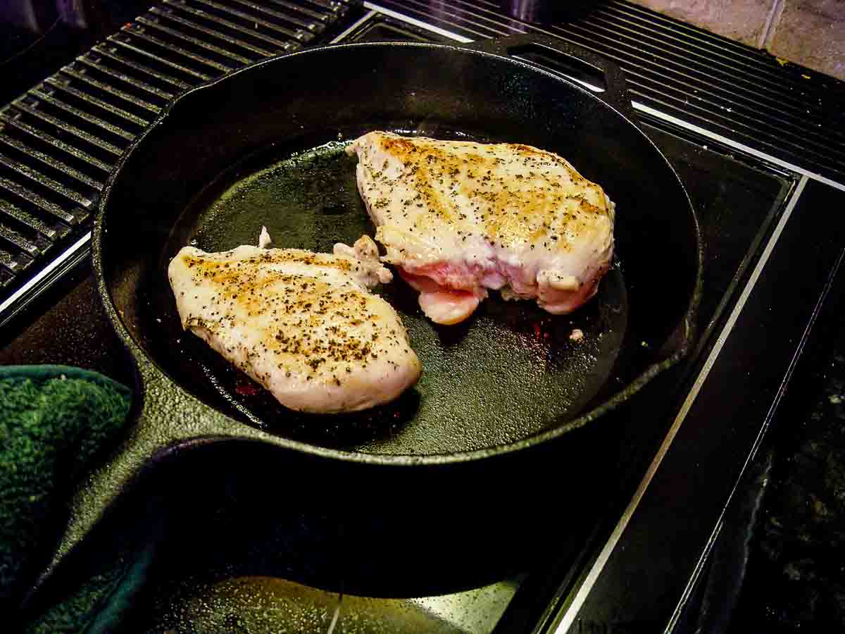 seared chicken breasts in black skillet