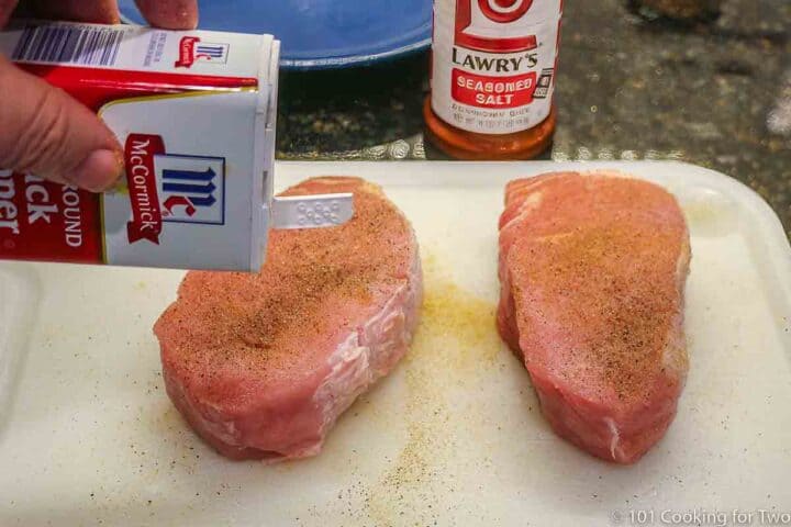 seasoning pork chops with pepper and seasoning salt