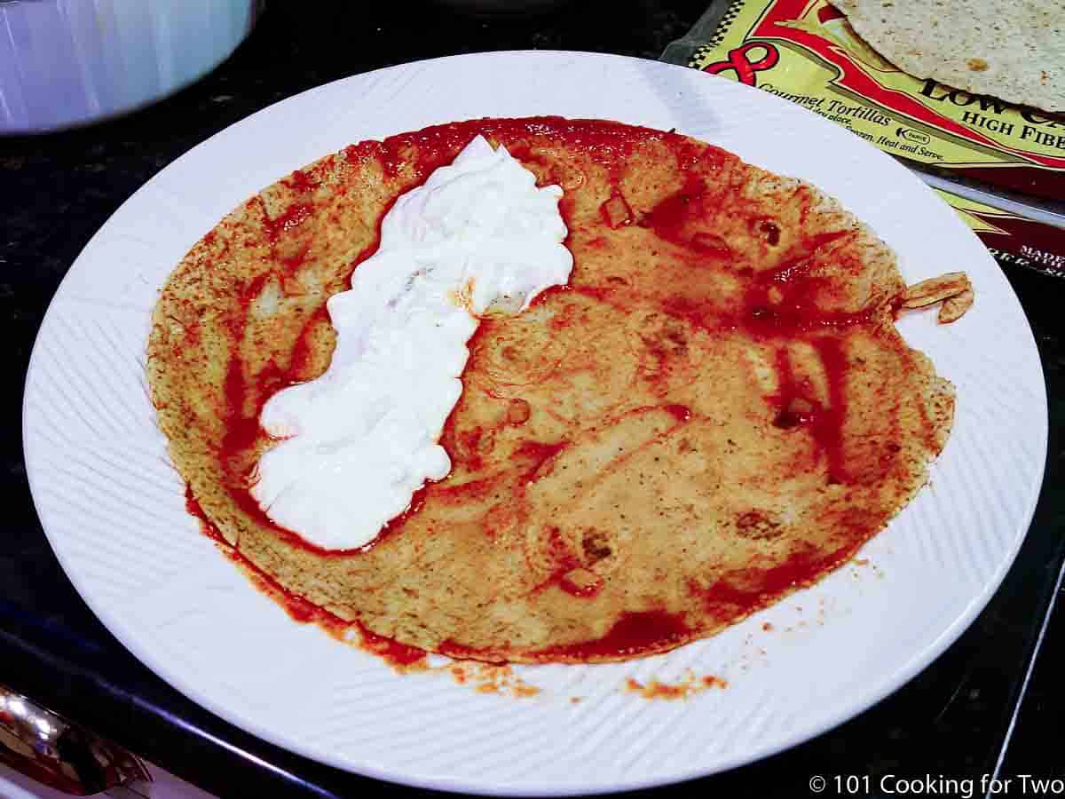 tortilla with sauce and sour cream.