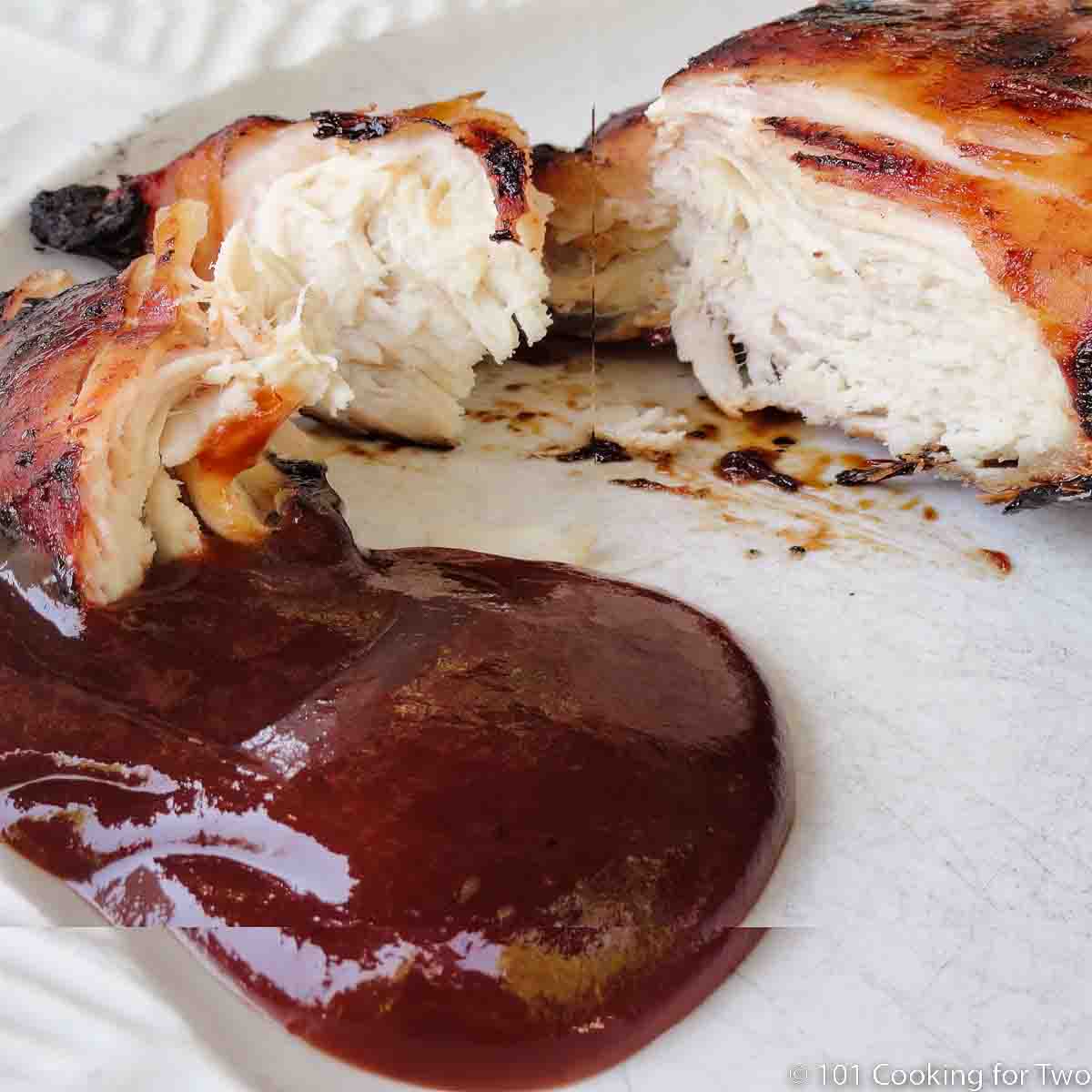 BBQ chicken breast on white plate.