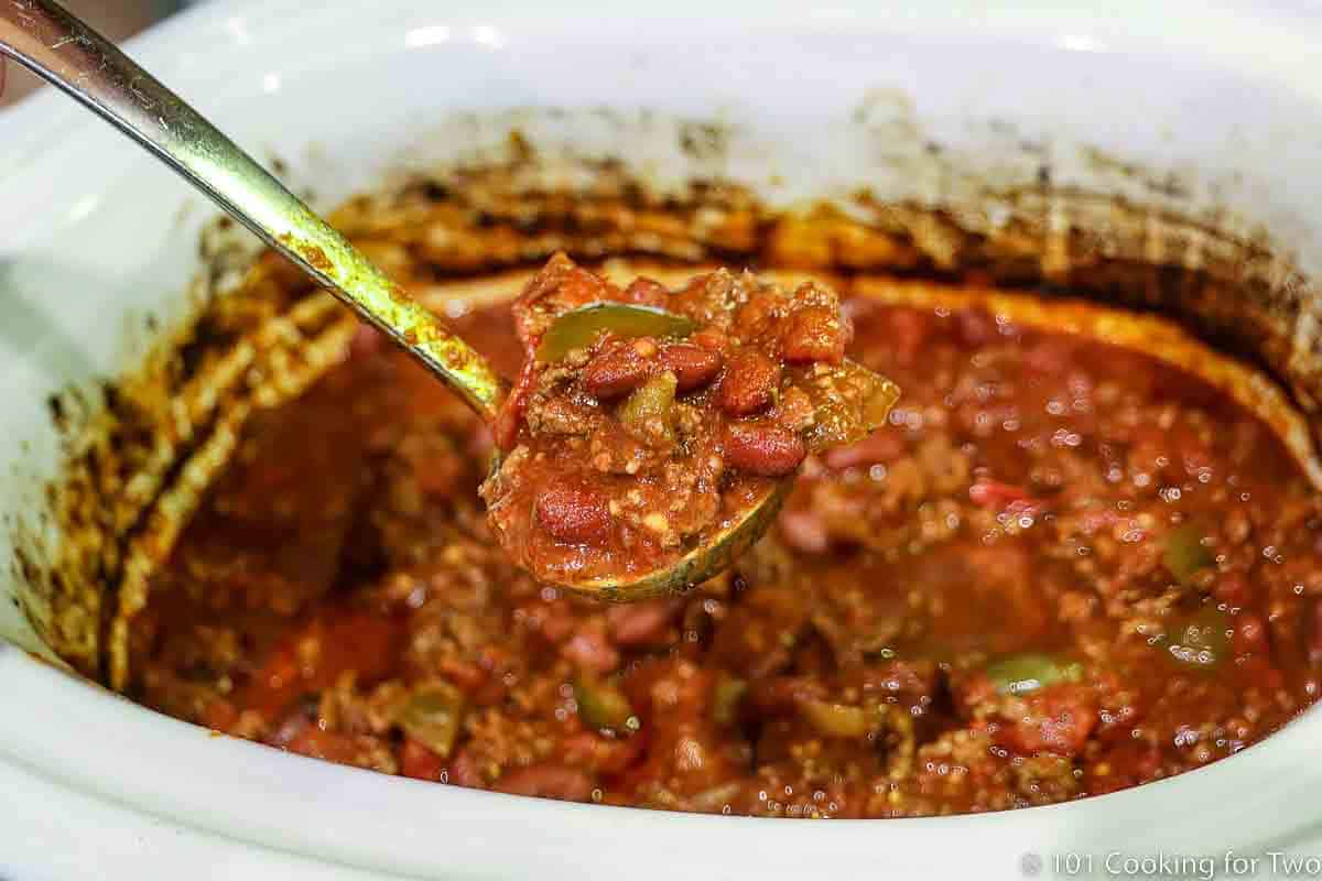 Ladle of chili over the crock pot
