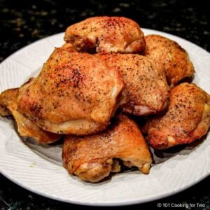Large plate of cooked chicken thighs.
