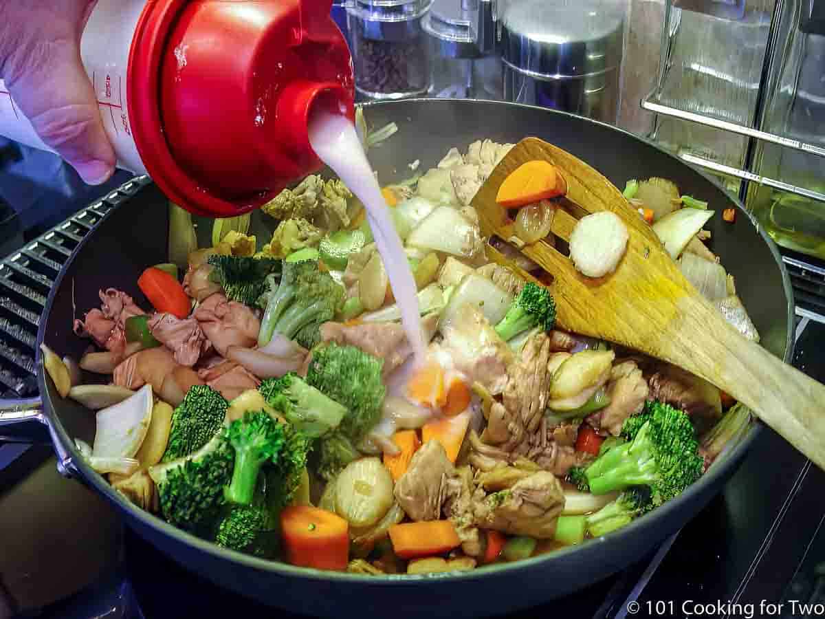 adding corn starch mixture to stir fry.