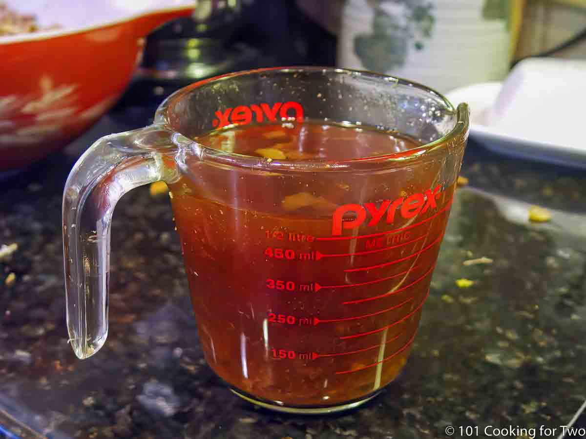 braising fluid in a measuring cup.