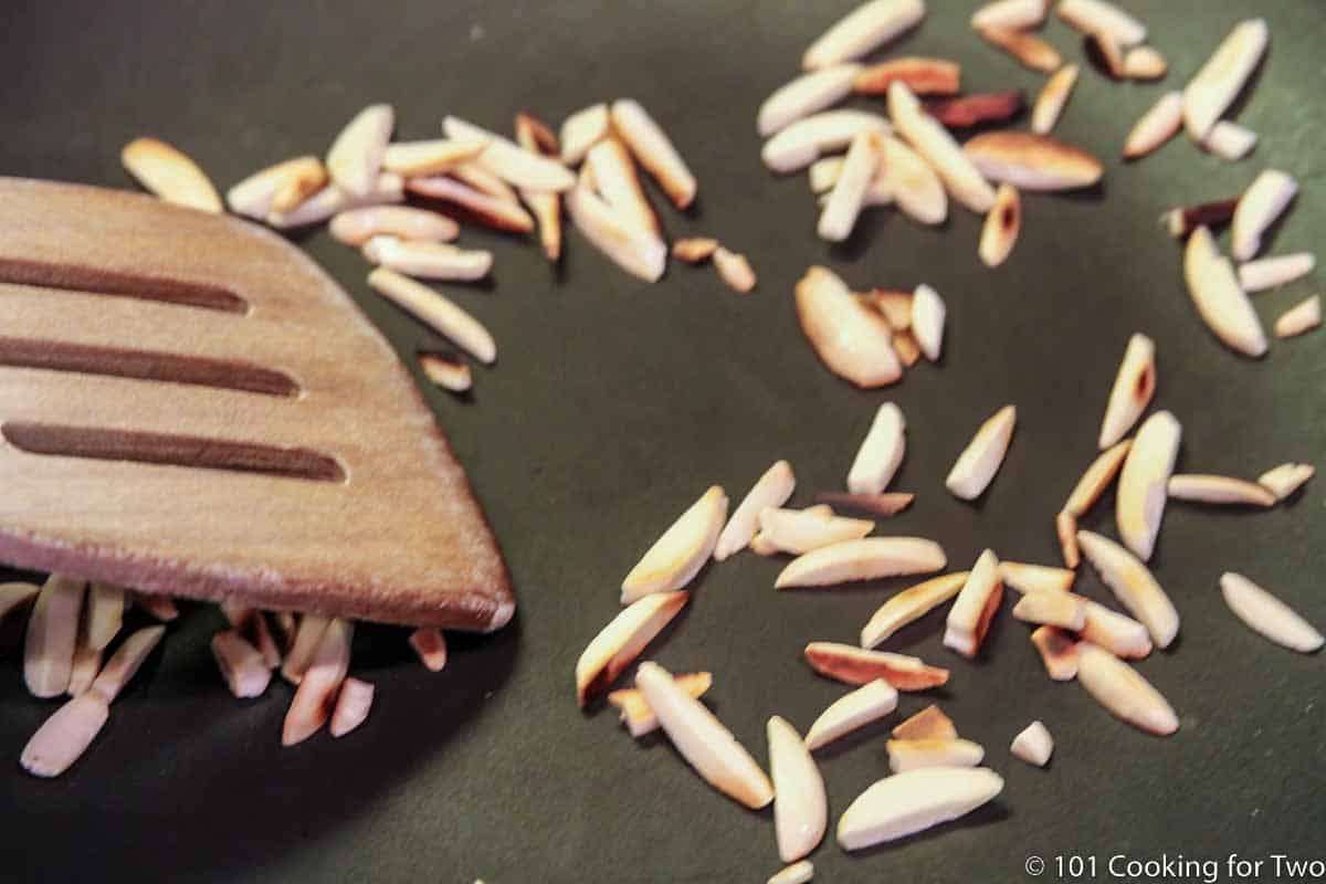 browing almond slivers in a pan.