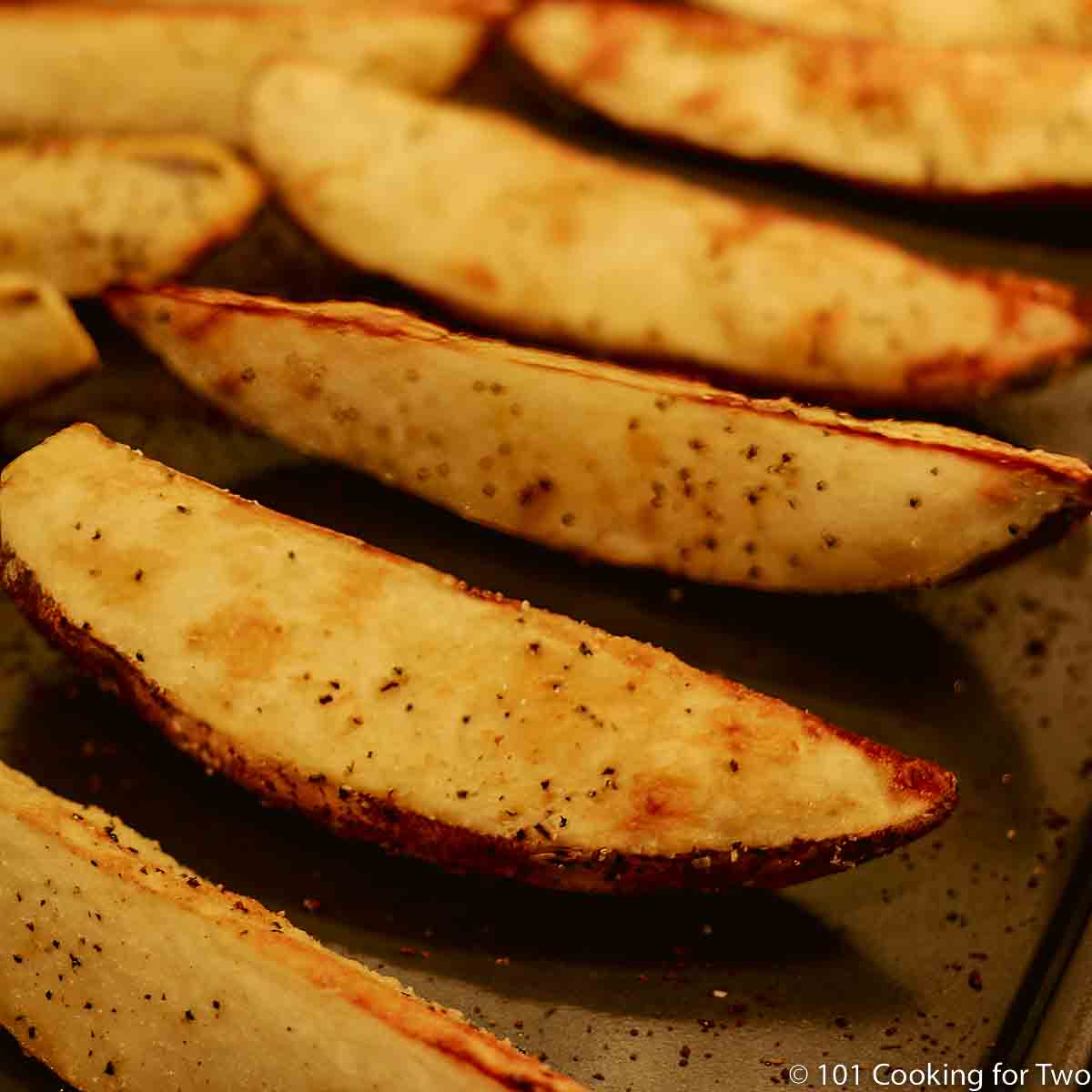 browned potato wedges on cooking tray.