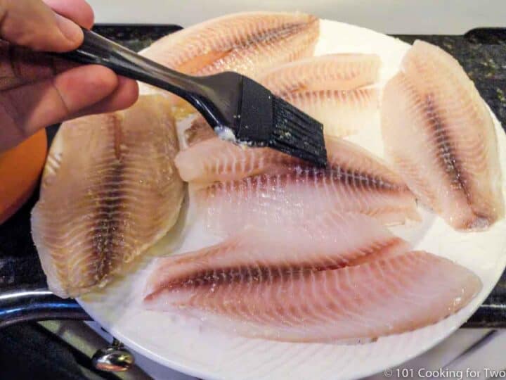 brushing tilapia with lemon butter