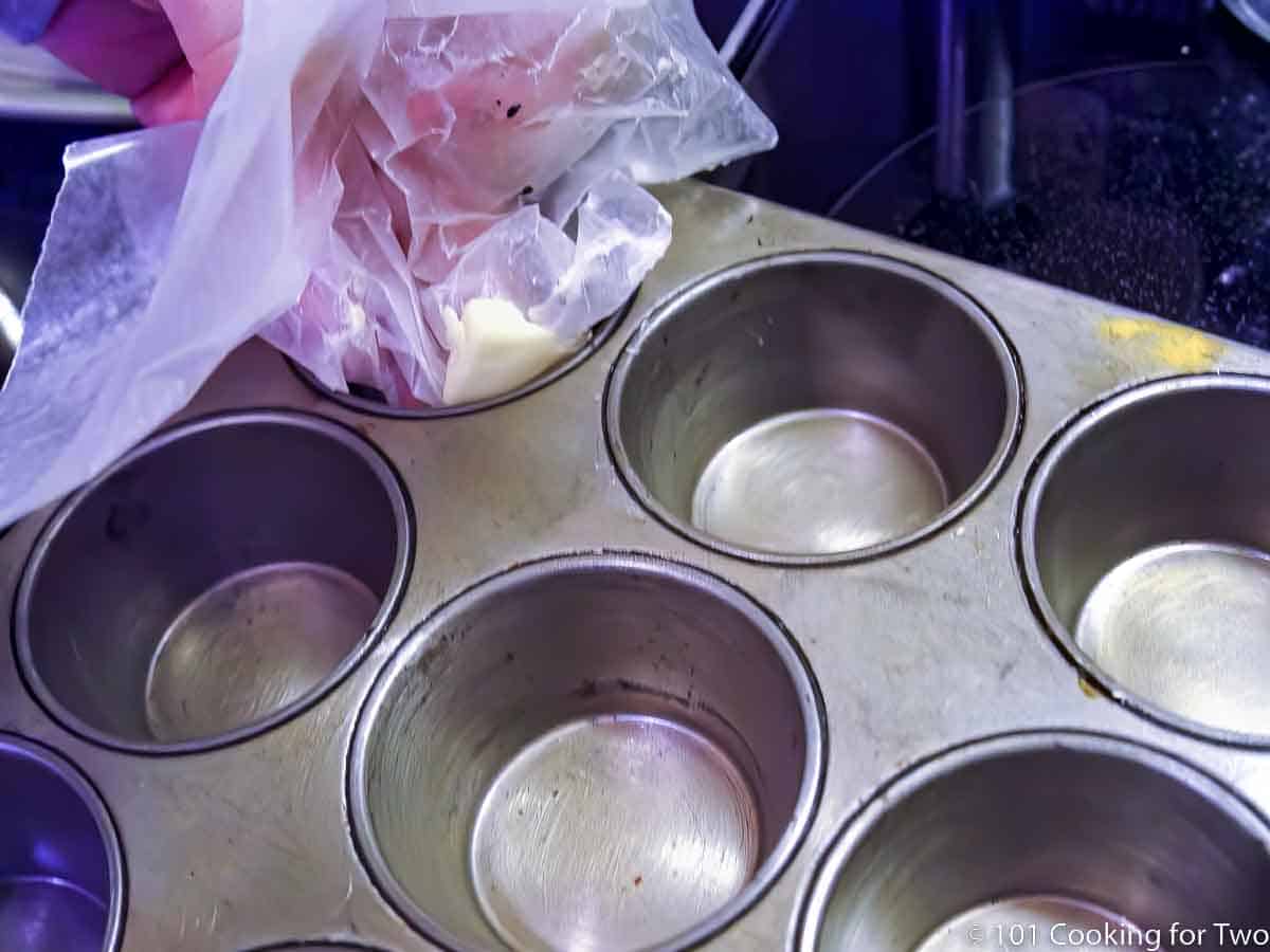 coating muffin tin with butter