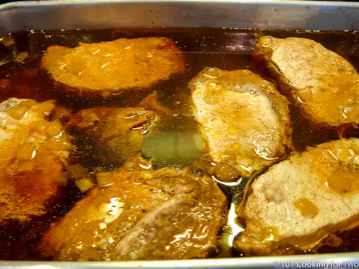 cooked pork loin in braising fluid.