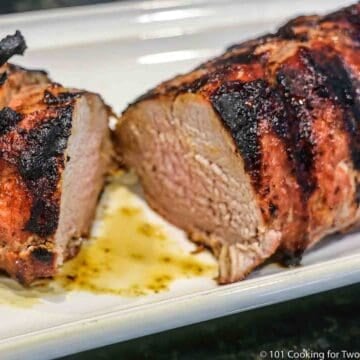 grilled pork tenderloin cut on white plate