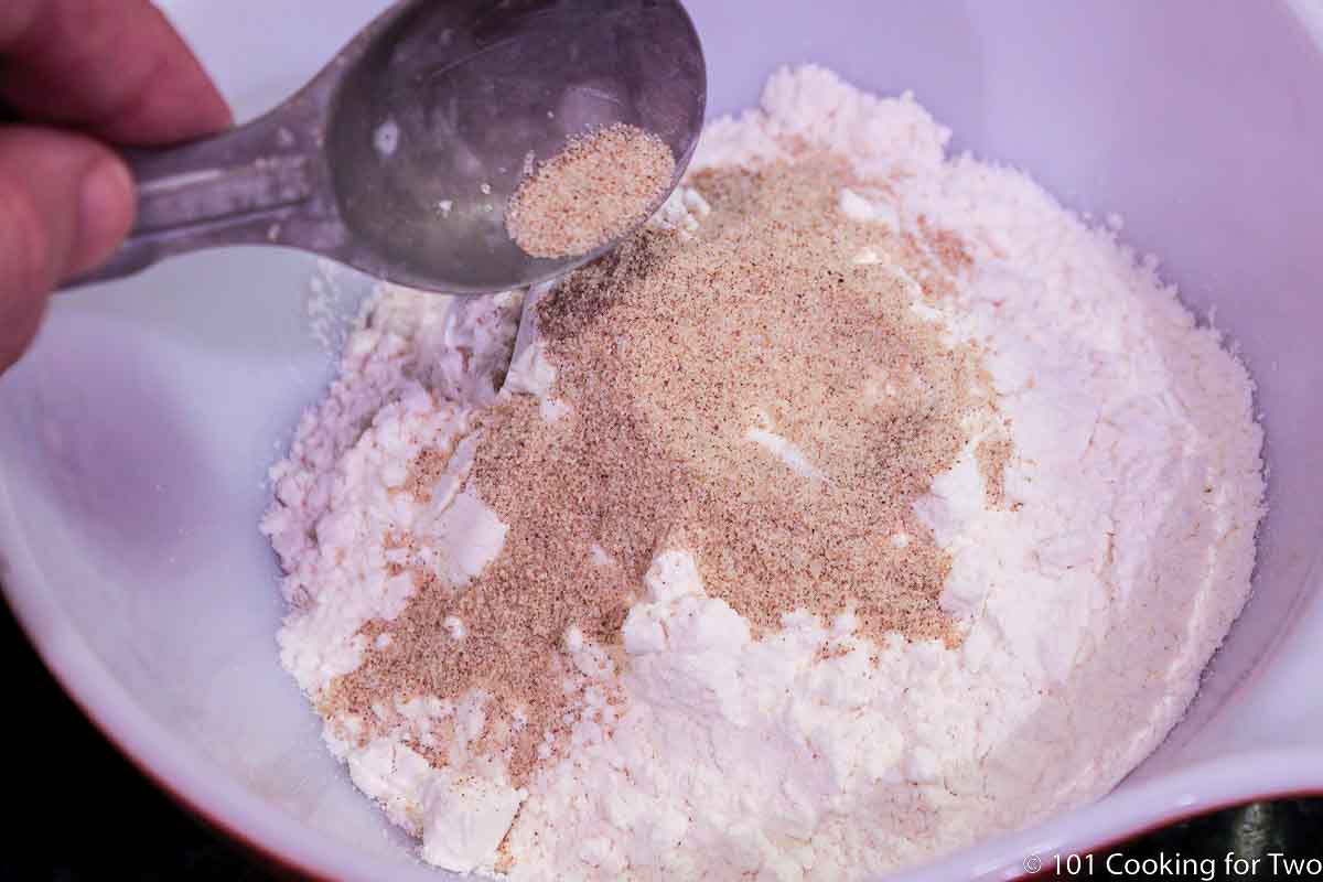 pouring seasoning salt into flour