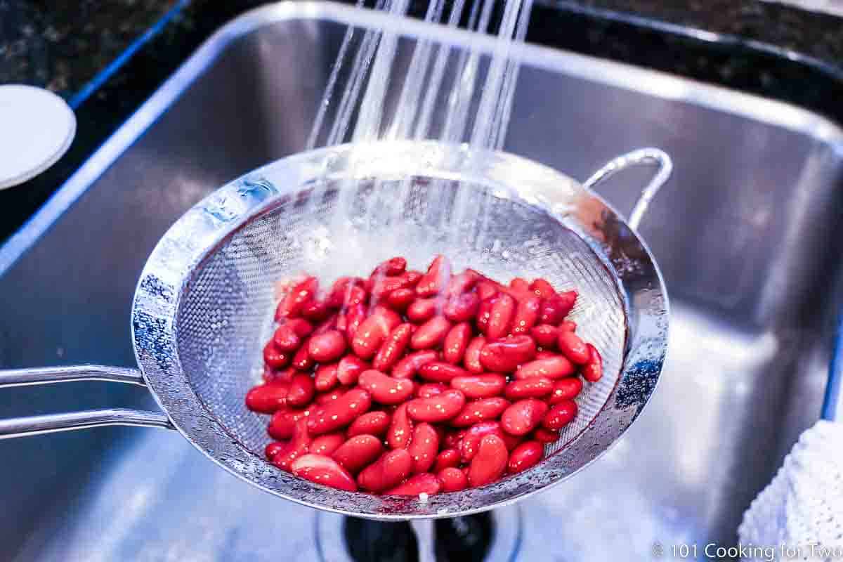 rinsing beans under running water.