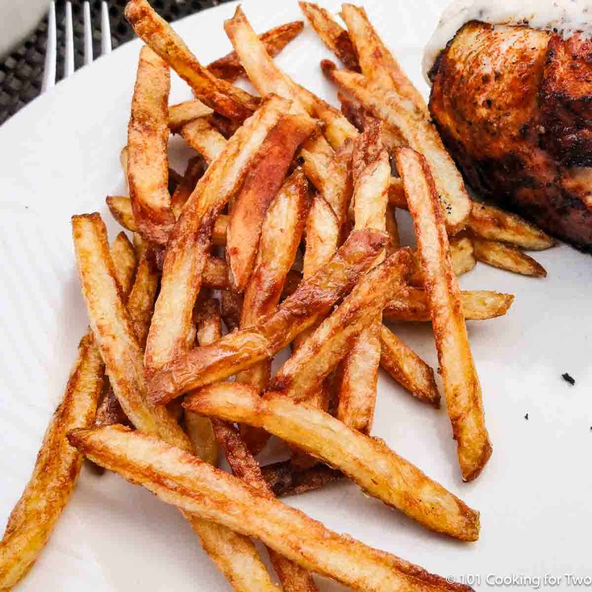 French fries on a white plate.